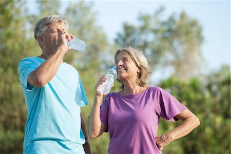 Senior couple drinking bottled water outdoors Stock Photo - Premium Royalty-Free, Code: 632-05760646
