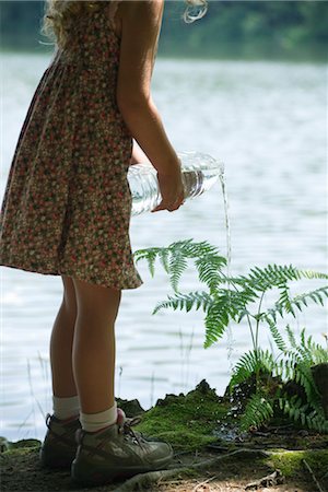simsearch:632-05759978,k - Girl watering plant with bottle of water Stock Photo - Premium Royalty-Free, Code: 632-05760641