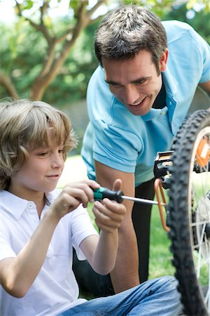 parent teaching outdoor - Father helping son repair bicycle Stock Photo - Premium Royalty-Free, Code: 632-05760659