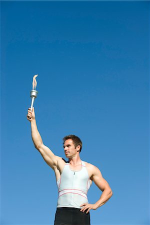 Male athlete holding up torch Foto de stock - Sin royalties Premium, Código: 632-05760650