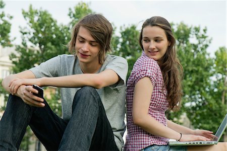 Young couple relaxing together outdoors with cell phone and laptop computer Stock Photo - Premium Royalty-Free, Code: 632-05816092