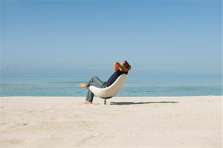 Mid homme relaxant en fauteuil sur la plage Photographie de stock - Premium Libres de Droits, Code: 632-05816139