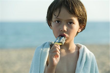 Boy eating popsicle, portrait Stock Photo - Premium Royalty-Free, Code: 632-05816133