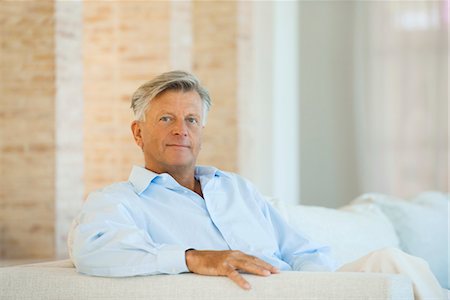 senior man eye contact one person - Senior man sitting on sofa, portrait Stock Photo - Premium Royalty-Free, Code: 632-05816253