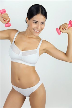 Woman in underwear lifting dumbbells Stock Photo - Premium Royalty-Free, Code: 632-05816315