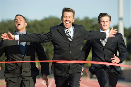 people competing - Businessman crossing finish line in race Stock Photo - Premium Royalty-Free, Code: 632-05816338