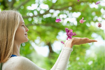 Young woman catching falling petals, side view Stock Photo - Premium Royalty-Free, Code: 632-05816357