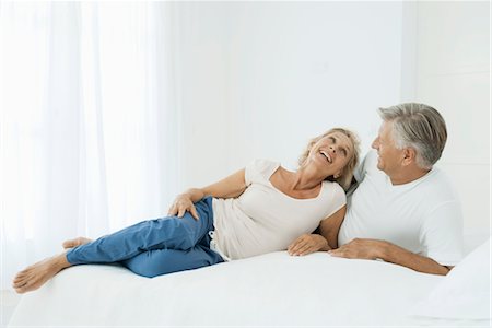 simsearch:632-05816872,k - Mature couple relaxing together on bed Stock Photo - Premium Royalty-Free, Code: 632-05816350