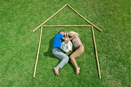 Little girl awake, parents sleeping, together within outline of house, high angle view Stock Photo - Premium Royalty-Free, Code: 632-05816360