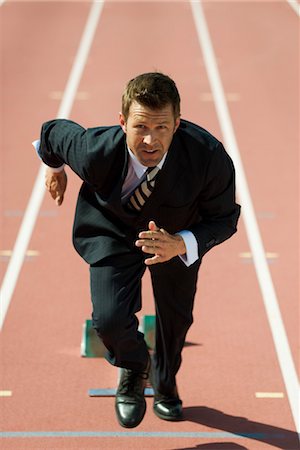 race concept - Businessman at starting line on running track Stock Photo - Premium Royalty-Free, Code: 632-05816424