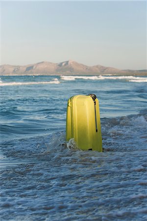 Wave breaking over suitcase Stock Photo - Premium Royalty-Free, Code: 632-05816475