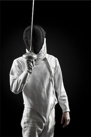 Fencer holding up foil, portrait Foto de stock - Sin royalties Premium, Código: 632-05816508