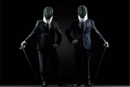 Businessmen with fencing masks and foils Stock Photo - Premium Royalty-Free, Code: 632-05816594