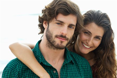 Young woman with arm around boyfriend, portrait Stock Photo - Premium Royalty-Free, Code: 632-05816593