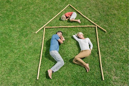 person asleep day - Family with one child lying on grass within outline of house, high angle view Stock Photo - Premium Royalty-Free, Code: 632-05816602