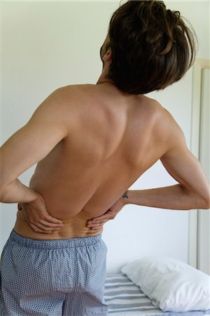 Man experiencing lower back pain Stock Photo - Premium Royalty-Free, Code: 632-05816617