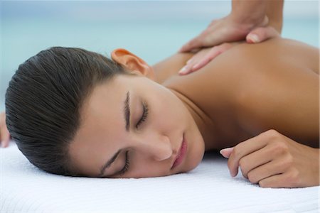 female eyes closed and shoulder - Young woman receiving back massage, cropped Stock Photo - Premium Royalty-Free, Code: 632-05816618
