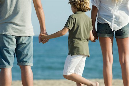 father son hold hands back - Boy holding parents' hands at the beach, rear view Stock Photo - Premium Royalty-Free, Code: 632-05816622