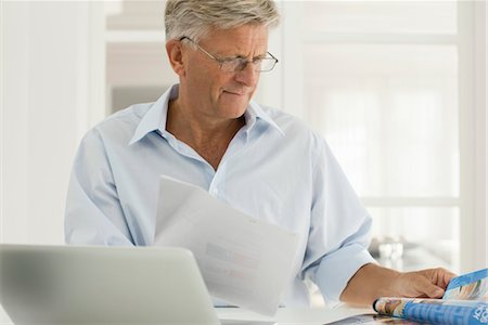 Senior man working on laptop computer at home Stock Photo - Premium Royalty-Free, Code: 632-05816657