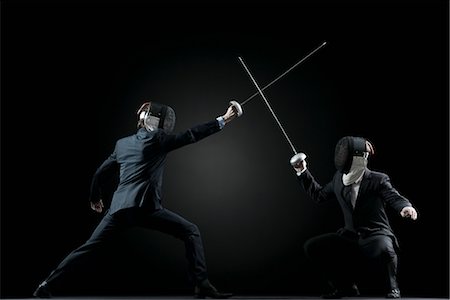 Businessmen fencing Fotografie stock - Premium Royalty-Free, Codice: 632-05816750