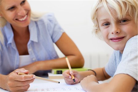 Boy doing homework, smiling at camera Foto de stock - Sin royalties Premium, Código: 632-05816761