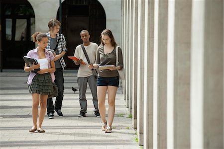 University students walking on campus discussing schoolwork Stock Photo - Premium Royalty-Free, Code: 632-05816808