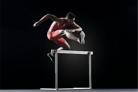 Male athlete clearing hurdle Foto de stock - Sin royalties Premium, Código: 632-05816829