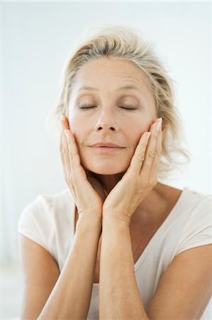 Mature woman touching her face, eyes closed, portrait Stock Photo - Premium Royalty-Free, Code: 632-05816822