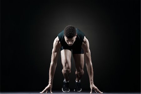 sprinter concentration - Runner at starting line Stock Photo - Premium Royalty-Free, Code: 632-05816850