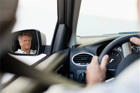 side mirror - Man driving car, reflected in driver's side mirror Stock Photo - Premium Royalty-Free, Code: 632-05816895