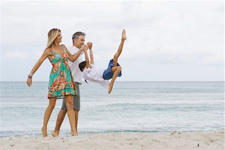 swinging - Parents swinging daughter while walking on beach Stock Photo - Premium Royalty-Free, Code: 632-05816916