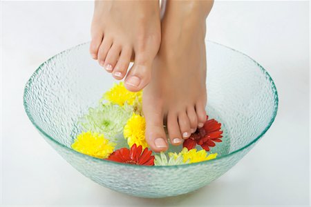 pedicure - Woman soaking feet in foot bath with flowers, cropped Stock Photo - Premium Royalty-Free, Code: 632-05816928