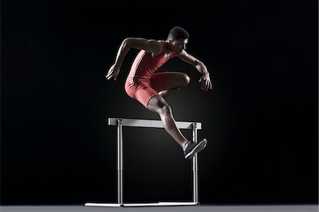 Male athlete cearling hurdle Stock Photo - Premium Royalty-Free, Code: 632-05817003