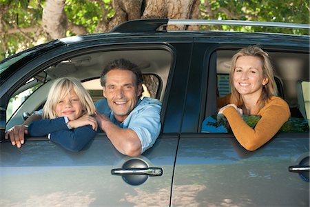father son car - Family together in car, leaning out windows and smiling at camera Stock Photo - Premium Royalty-Free, Code: 632-05817031