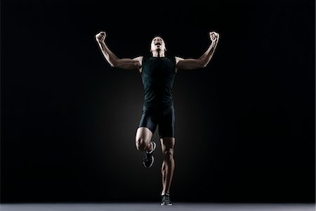 Male athlete flexing arms and shouting Stock Photo - Premium Royalty-Free, Code: 632-05817072