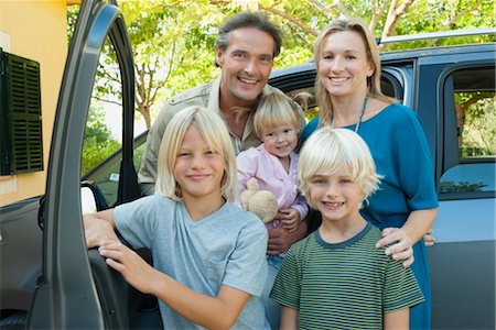 portrait of woman and her boy smiling - Family posing beside car, portrait Stock Photo - Premium Royalty-Free, Code: 632-05817099