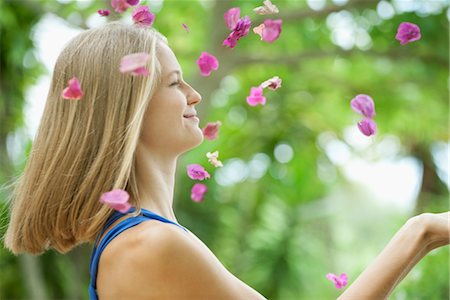 Young woman throwing petals in air, side view Stock Photo - Premium Royalty-Free, Code: 632-05817141