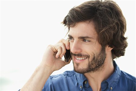 portrait young man white background - Man using cell phone outdoors Stock Photo - Premium Royalty-Free, Code: 632-05844997