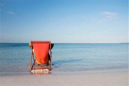 sitting beach - Man sitting in deckchair looking at ocean, rear view Stock Photo - Premium Royalty-Free, Code: 632-05845080