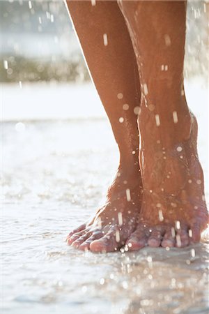 simsearch:632-03847895,k - Feet under shower outdoors Stock Photo - Premium Royalty-Free, Code: 632-05845184