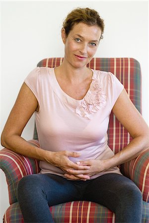 Mature woman sitting in armchair, portrait Stock Photo - Premium Royalty-Free, Code: 632-05845228