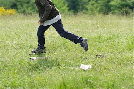 people walking tennis shoes - Boy running in meadow, low section Stock Photo - Premium Royalty-Free, Code: 632-05845247