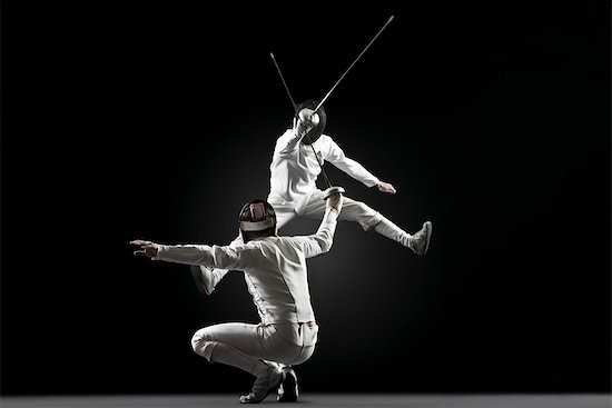 Fencers fencing, one fencer jumping in air Stock Photo - Premium Royalty-Free, Image code: 632-05845254