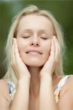 Young woman with head in hands and eyes closed Stock Photo - Premium Royalty-Free, Code: 632-05845259