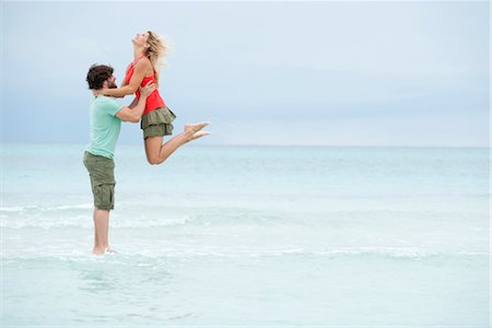 Couple at the beach, man lifting woman in air Stock Photo - Premium Royalty-Free, Code: 632-05845378