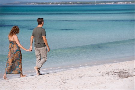 Could walking on beach holding hands Stock Photo - Premium Royalty-Free, Code: 632-05845404