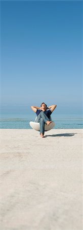 Man relaxing in chair on beach Stock Photo - Premium Royalty-Free, Code: 632-05845439