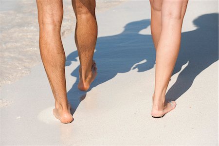 simsearch:632-05991314,k - Couple walking on beach, low section Stock Photo - Premium Royalty-Free, Code: 632-05845661