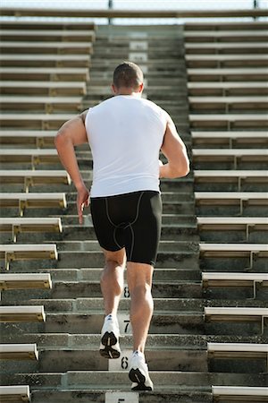 exercise men backside - Man running up steps in stadium, rear view Foto de stock - Sin royalties Premium, Código: 632-05991111