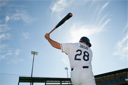 Baseball player swinging bat, rear view Fotografie stock - Premium Royalty-Free, Codice: 632-05991375